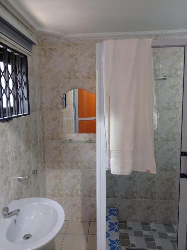 a bathroom with a shower with a sink and a shower at El-Edu Villa in Oshien