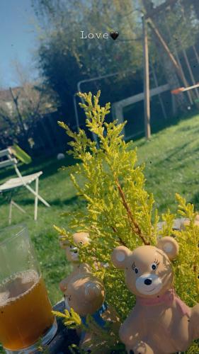 a teddy bear sitting next to a small tree at Rez chaussée transformé en t4 au 114 Avenue de juvisy cottages in Juvisy-sur-Orge
