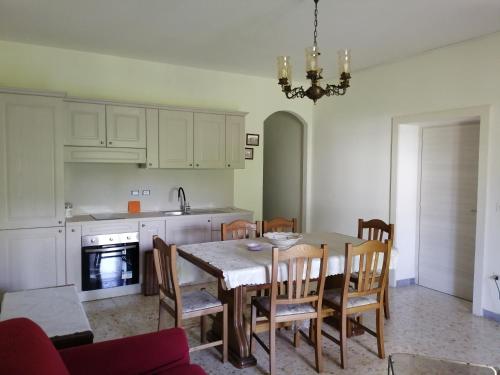 a kitchen with a table and chairs and a dining room at Casa di Biagio e Maria in Trecchina