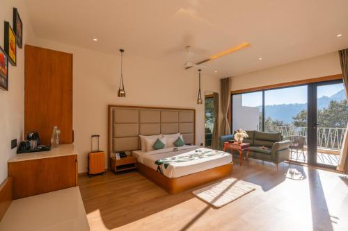 a bedroom with a bed and a living room at Moustache Select Nainital- Onsite Parking in Nainital