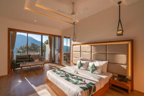 a bedroom with a large bed and a couch at Moustache Select Nainital- Onsite Parking in Nainital