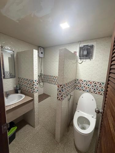 a small bathroom with a toilet and a sink at Noahs Ark Beachfront in Lamai