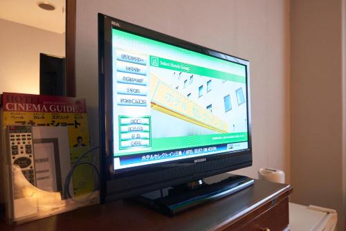 a flat screen tv sitting on top of a table at Select Inn Mishima in Mishima