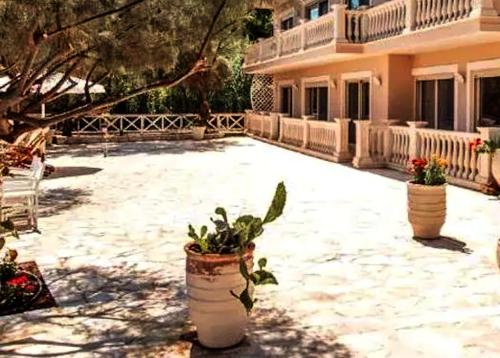 a courtyard of a house with two potted plants at Centrally located in Gaios