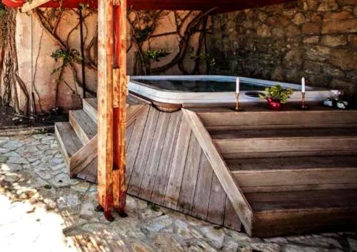a bath tub sitting on top of a wooden deck at Centrally located in Gaios