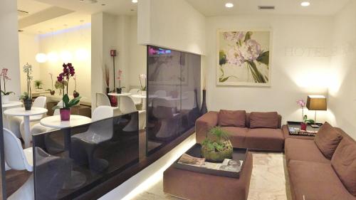 a living room with a couch and a table at Hotel Sempione in Milan