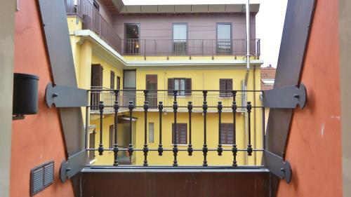 a view of a yellow building with a balcony at Hotel Sempione in Milan