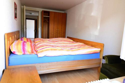 a bedroom with a bed with a colorful blanket on it at Residence Jungfrau in Interlaken