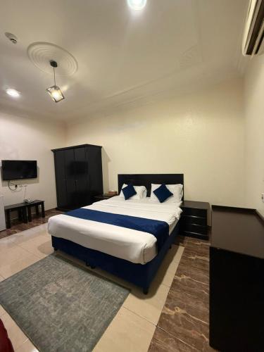 a bedroom with a bed and a television in it at مساكن المبيت 5 new in Abha