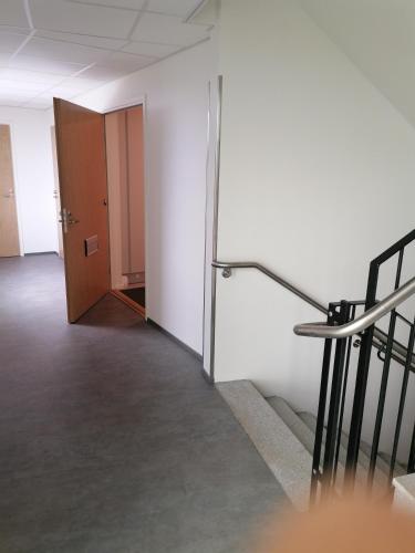 an empty room with stairs and a door at Prince Palace in Vantaa