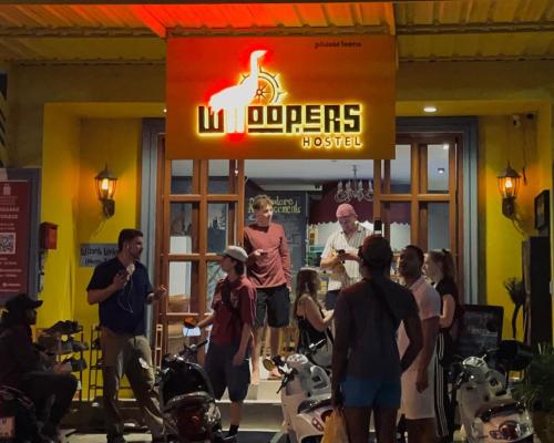 a group of people standing outside of a store at Whoopers Hostel Chiang Mai - Harry Potter Themed in Chiang Mai