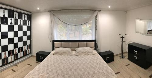 a bedroom with a large bed and a window at Apartment at Kvitka Polonyny in Solochin