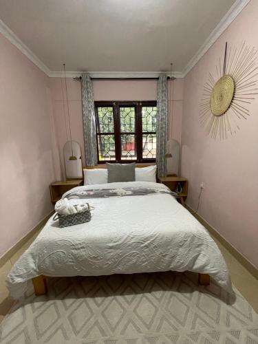 a bedroom with a large bed and a window at Serene homes in Mwanza