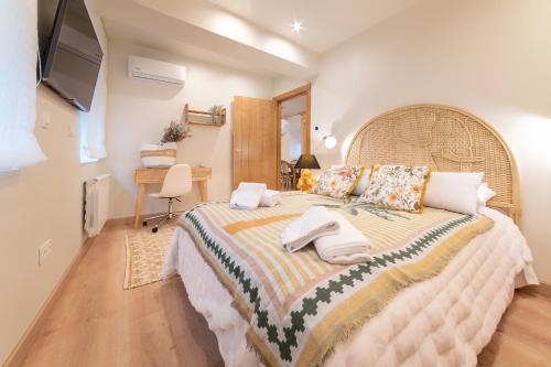 a bedroom with a large bed with towels on it at Cangas de Onís CENTRO in Cangas de Onís