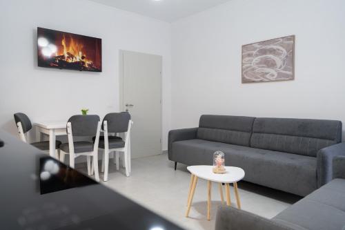 a living room with a couch and a table at Greca Apartments in Sauk