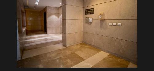 an empty bathroom with ailed floor and a hallway at Maison 7 New Cairo in Cairo