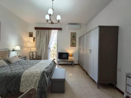 a bedroom with a large bed and a large cabinet at Malta Airport B&B bedroom with private shower