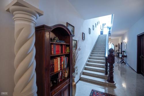 a stairway with a book shelf and a staircase at Malta Airport B&B bedroom with private shower