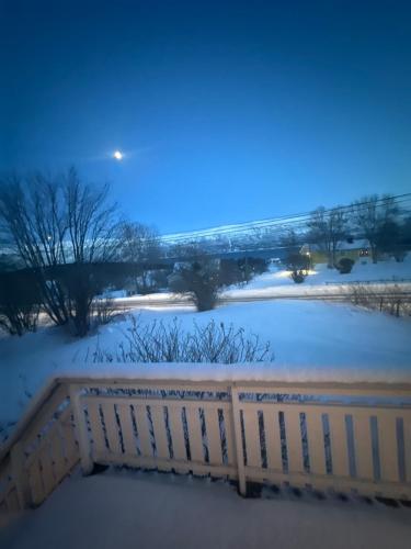 a fence in the snow at night at Holiday home for rent in Lyngen