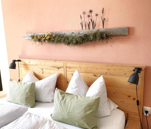 a bedroom with a bed with white pillows at Wiesen-Hof in Günzach