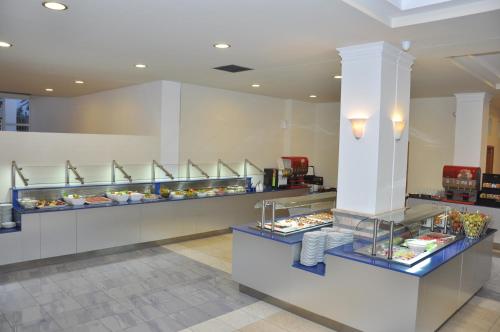 a buffet line with plates of food on display at Zorbas Beach Hotel in Tigaki