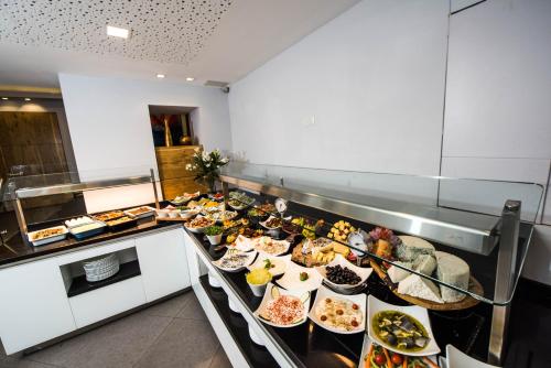 a buffet line with many different types of food at Montefiore Hotel By Smart Hotels in Jerusalem