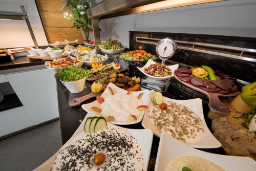 a buffet line with many different types of food at Montefiore Hotel By Smart Hotels in Jerusalem