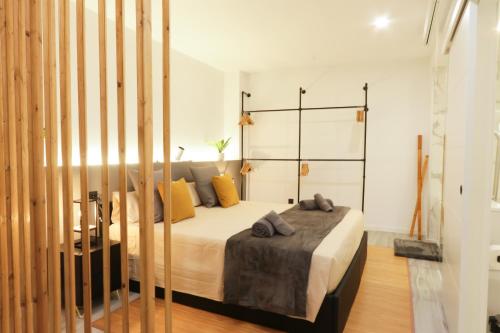 a bedroom with a bed with yellow pillows at Sweet Suites in Valencia