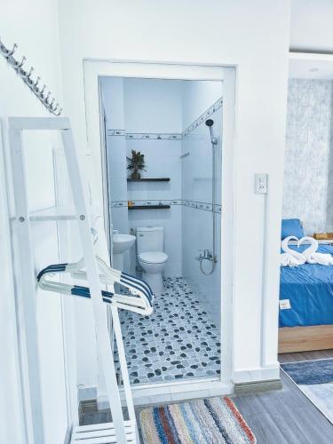 a white bathroom with a toilet and a ladder at Miha Villa 3 - House in Can Tho in Can Tho