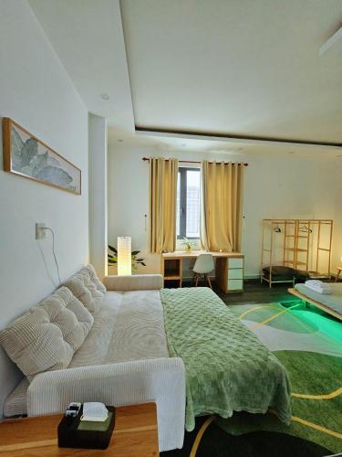 a bedroom with a bed and a table and a desk at Miha Villa 3 - House in Can Tho in Can Tho