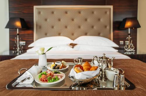 a white table topped with two plates of food at The Biltmore Tbilisi Hotel in Tbilisi City