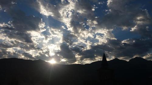 a silhouette of a church against a cloudy sky at Les Rochers in Saint-Savin