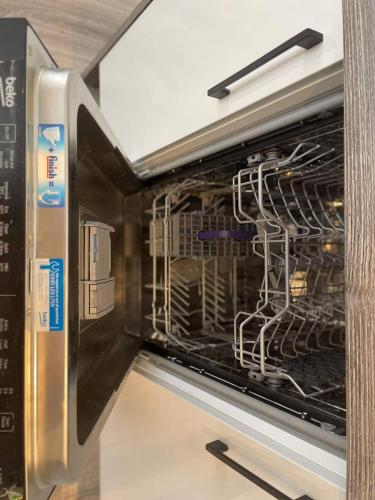 a microwave oven with its door open with dishes inside at Exclusive 1 and 2 Bedroom Flats only 0,5 miles aw in Bicester