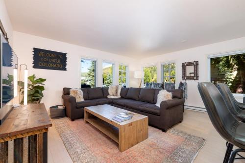 a living room with a couch and a coffee table at Premier Downtown Telluride Condo with Pool, Hot Tub & Parking in Telluride