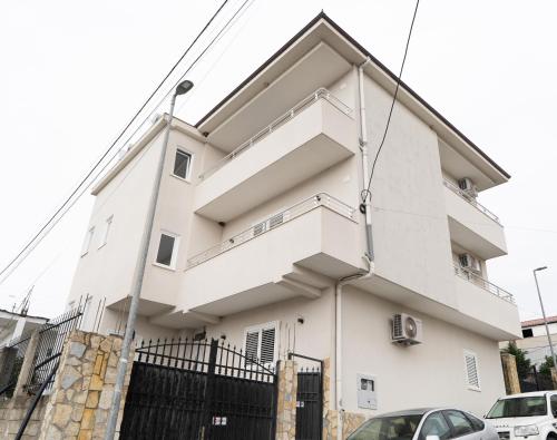 a white building with a balcony on it at Greca Apartments in Sauk