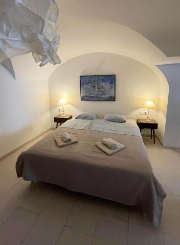 a bedroom with a bed with two towels on it at Art apartment Kranj in Kranj