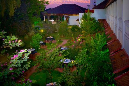 an aerial view of a garden with tables and flowers at The Mascot Hotel - A Heritage Living Experience in Trivandrum