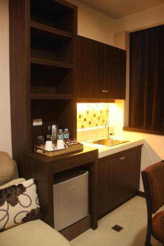 a small kitchen with a sink and a counter at Kew Hotel Tagbilaran in Tagbilaran City