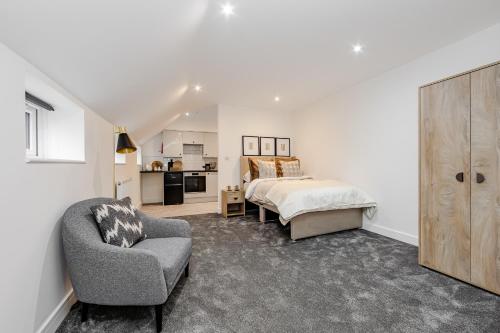 a bedroom with a bed and a chair at Studio Room, Parking, Contractors and Relocators, Weekly Deals in Maidstone