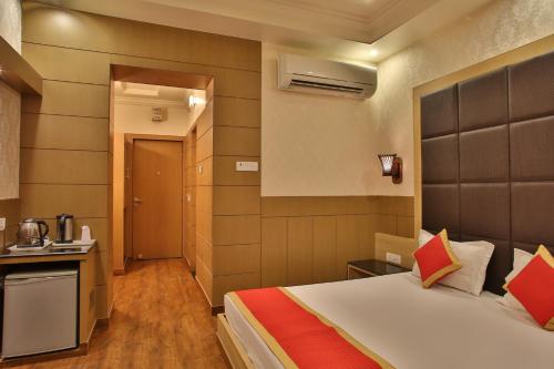 a hotel room with a bed and a kitchen at Hotel The Grand Chandiram in Kota