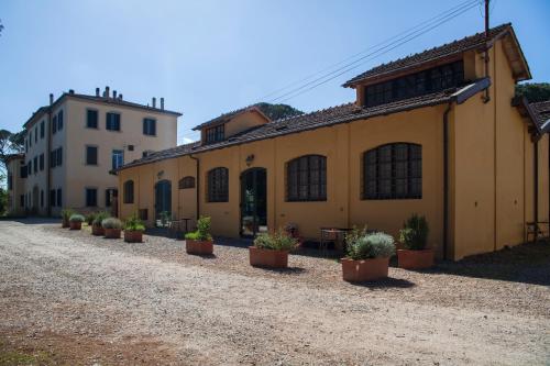 a row of potted plants inront of a building at Tenuta di Paganico - I Roggeti in Paganico