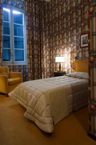 a bedroom with a large bed and a window at Hotel Villa La Principessa in Lucca