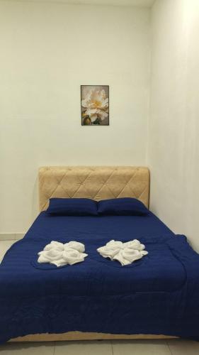 a bed with two towels on top of it at NJAZ Homestay Perlis in Arau