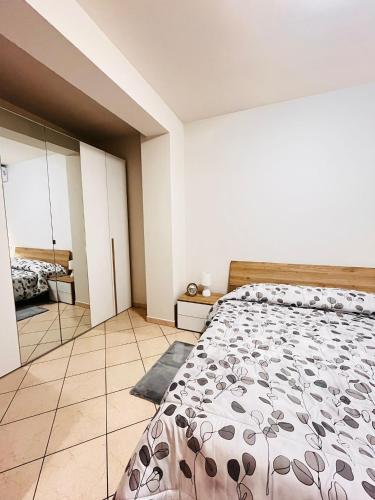 a bedroom with a bed and a mirror at Elisabeth home in Modica