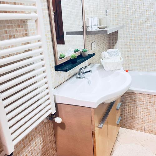 a bathroom with a sink and a mirror at Elisabeth home in Modica