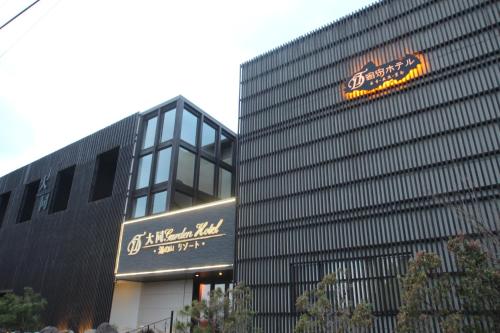 a building with a sign on the side of it at 大同 Garden Hotel 湯の山リゾート in Komono