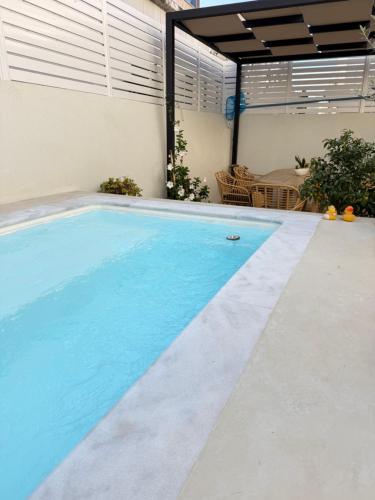 a swimming pool in a house at Myronos suite with jacuzzi in Piraeus