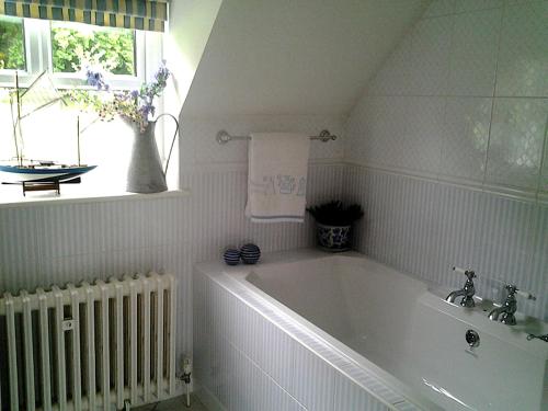 a white bath tub in a bathroom with a window at Drumhierney Lodge in Leitrim