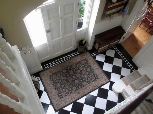 an open door with a checkered floor in a room at Drumhierney Lodge in Leitrim