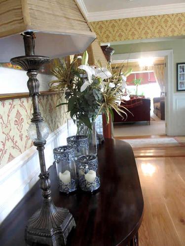 a table with candles and flowers in a living room at Drumhierney Lodge in Leitrim